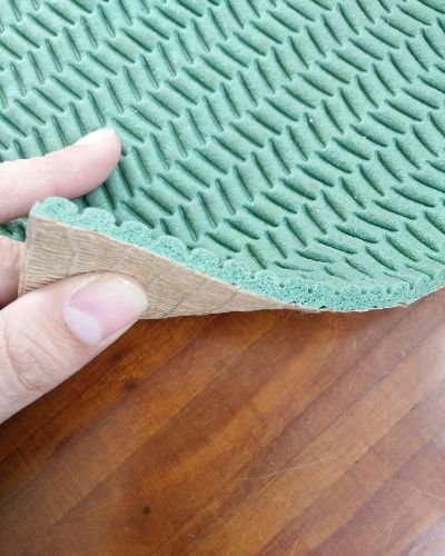 A man holding carpet underlay